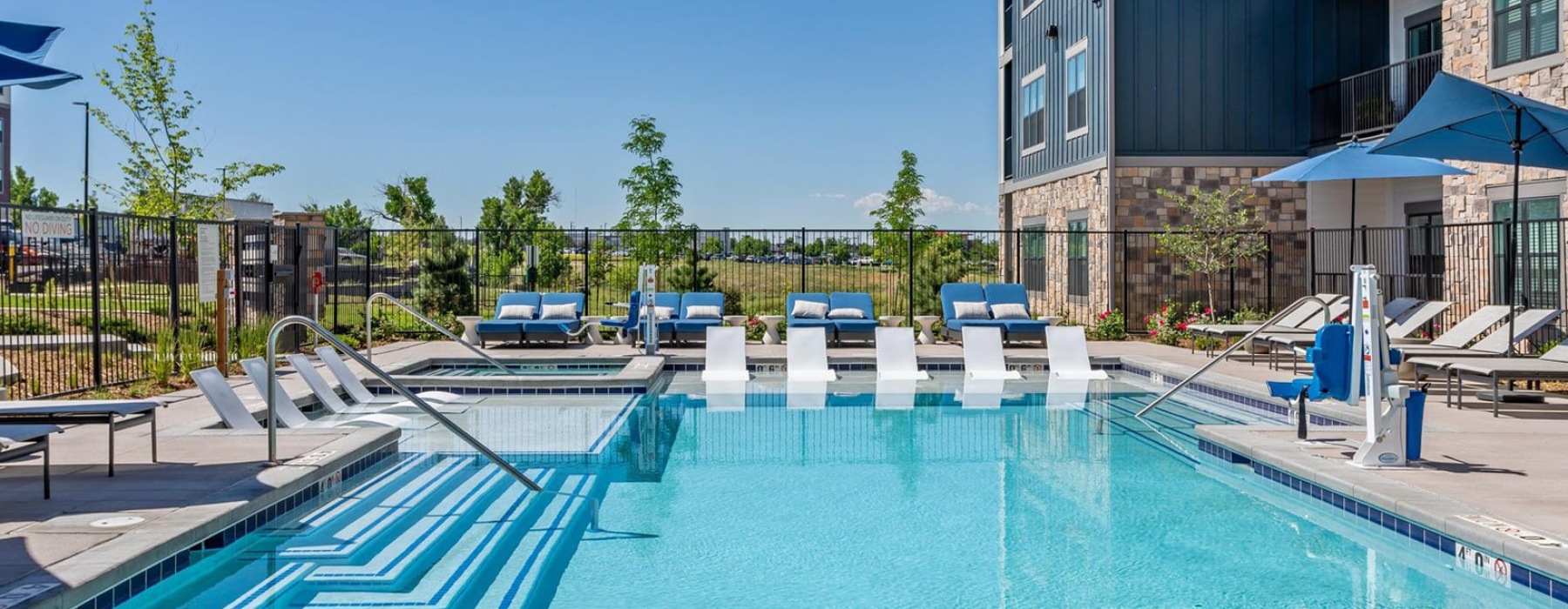 Resort-style swimming pool with lounge seating